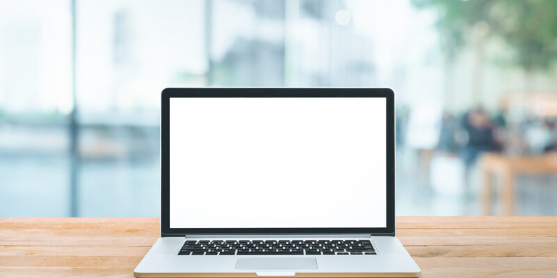 Modern computer,laptop with blank screen on counter bar(retail store shop)and window view